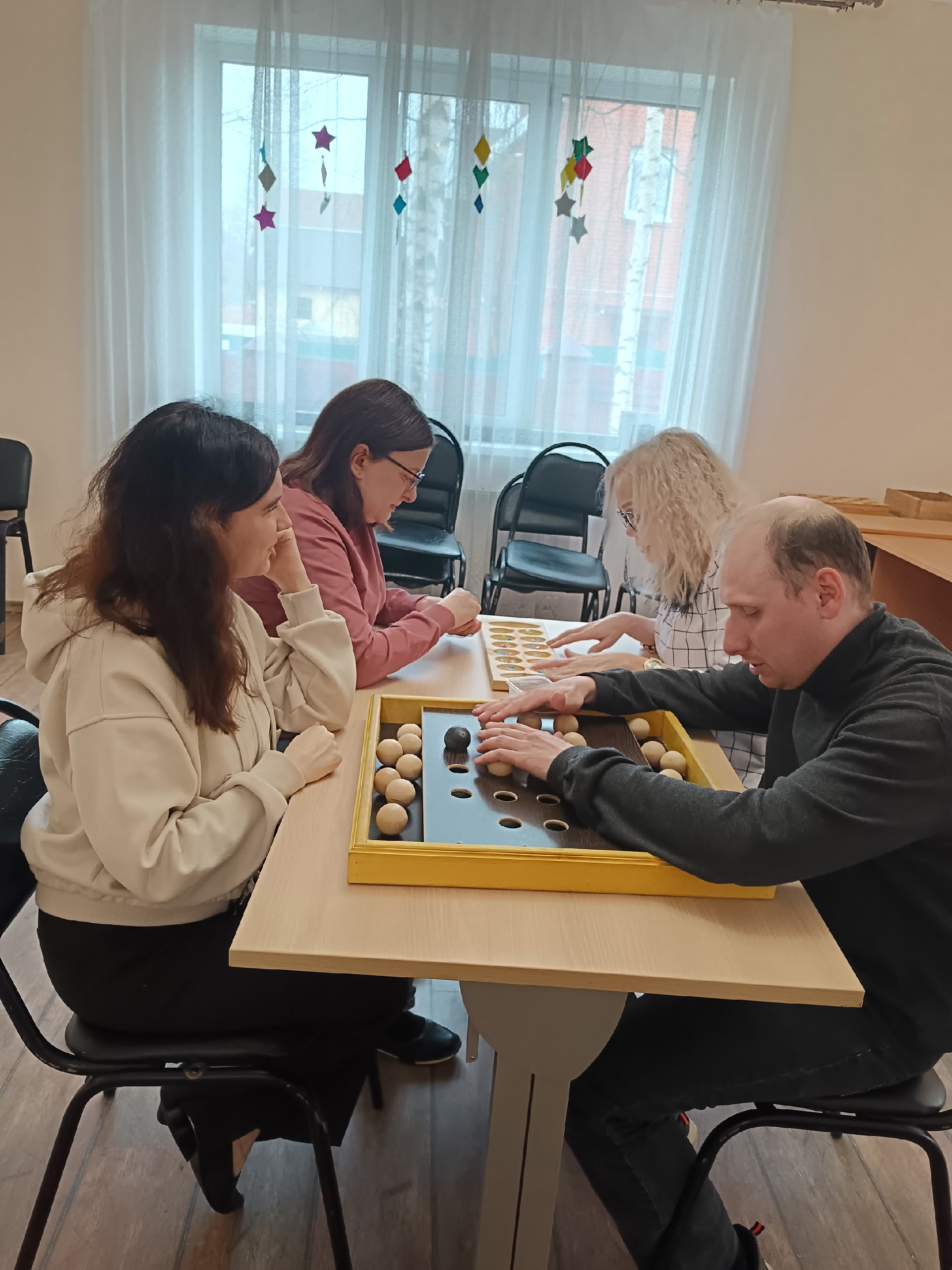 Четыре человека играют в настольные игры