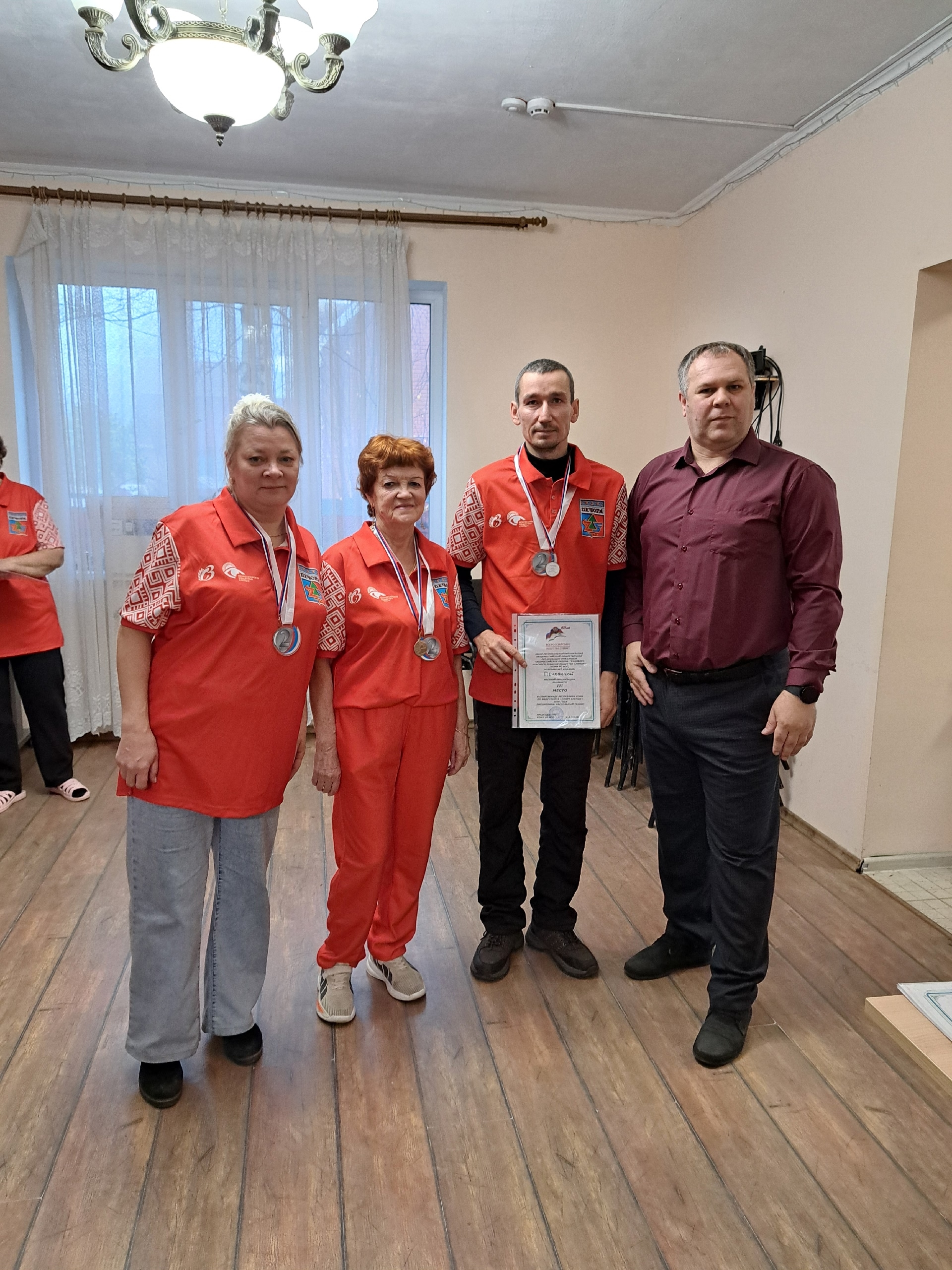 Участники спартакиады в красной форме с медалями и дипломом